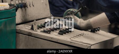 Industrial worker operating machine on control panel in metal industry. Concept for metalwork production.Close up. Stock Photo