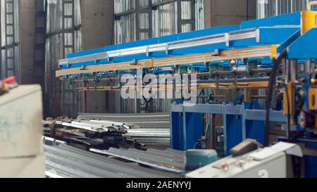 The industrial device for sheet metal bending by high precision machine in factory. Line machine conveyor for cutting sheet metal in mechanical worksh Stock Photo
