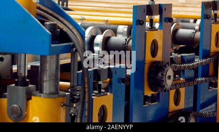 The industrial device for sheet metal bending by high precision machine in factory. Line machine conveyor for cutting sheet metal in mechanical worksh Stock Photo
