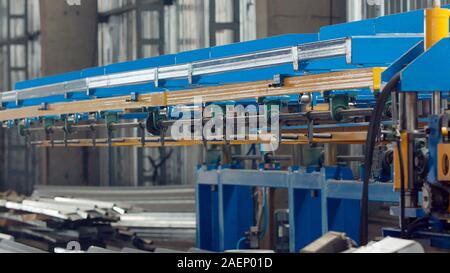 The industrial device for sheet metal bending by high precision machine in factory. Blue line machine conveyor for cutting sheet metal in mechanical w Stock Photo