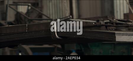 Aluminum metal sheets stacked big wire rope sling onto crane block in preparation of heavy lifting. Concept for heavy industry production. Stock Photo