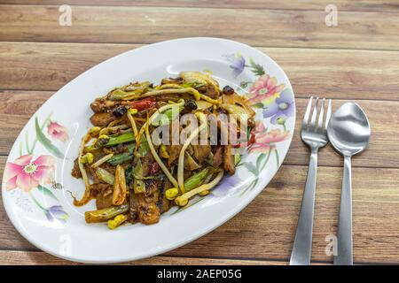 Stir-fry spicy sliced beef with bean sprouts, dried chillies and spring onions. Authentic China Chinese Asian food on table. Stock Photo
