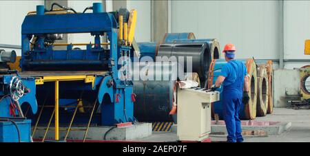 Engineer checking and controlling automatic machine in mechanical workshop, monitoring system software. Digital manufacturing operation. Concept for m Stock Photo