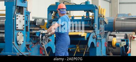 Engineer checking and controlling automatic machine in mechanical workshop, monitoring system software. Digital manufacturing operation. Concept for m Stock Photo
