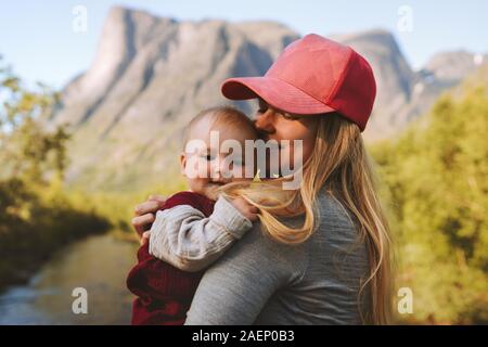 Mother and baby daughter family traveling together enjoying mountains view healthy lifestyle mom and child active vacations outdoors Mothers day Stock Photo