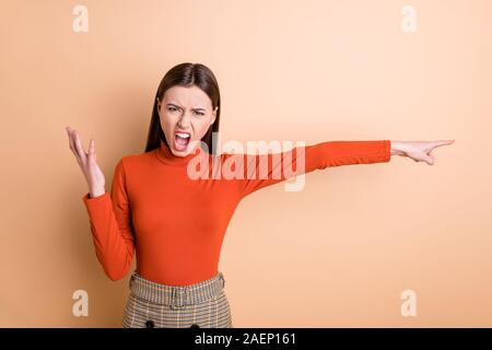 Portrait of her she nice attractive crazy gloomy frustrated outraged strict bossy straight-haired girl pointing aside kick you out isolated over beige Stock Photo