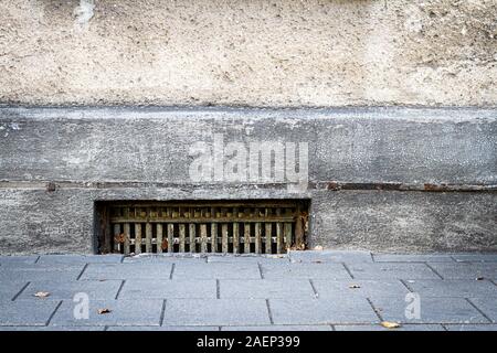 Old cracked graywall with a basement window Stock Photo