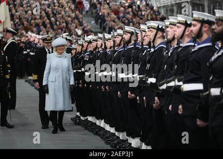 The Duchess of Cornwall inspects members of the ship's company during the commissioning ceremony of the Royal Navy aircraft carrier, HMS Prince of Wales, at Portsmouth Naval Base. Stock Photo