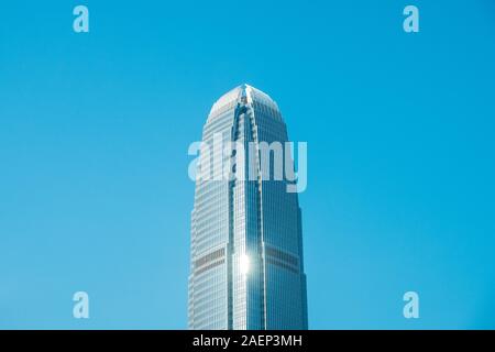 HongKong, China - November, 2019: Top of the two International Finance Centre skyscraper building in Central Hong Kong on clear blue sky Stock Photo