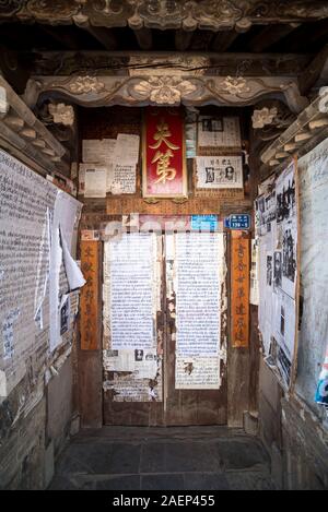 March 7 2019: walls covered with article and news of Chinese newspapers in Jianshui, China Stock Photo