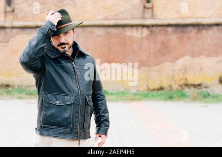 man with jacket and hat in the street Stock Photo