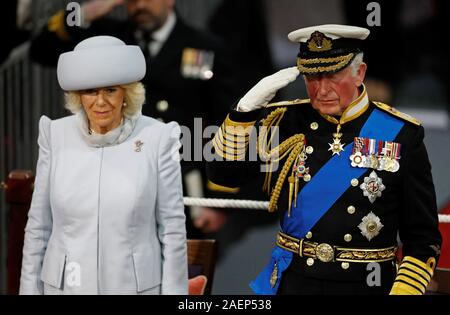 The Prince of Wales salutes the White Ensign watched by the Duchess of Cornwall, during the commissioning ceremony of the Royal Navy aircraft carrier, HMS Prince of Wales, at Portsmouth Naval Base. Stock Photo