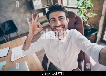 Close up photo of positive middle eastern collar ceo worker having online connection meeting on team working training make selfie show ok sign approve Stock Photo