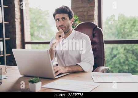 What answer.... Portrait of doubtful thoughtful middle eastern business man using his laptop communicate with enterprise partners investors want find Stock Photo