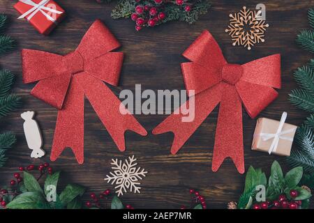 Top above high angle close up view photo of two big nice charming with glitter bow lying on dark wooden rustic desk with candies snow snowflakes Stock Photo