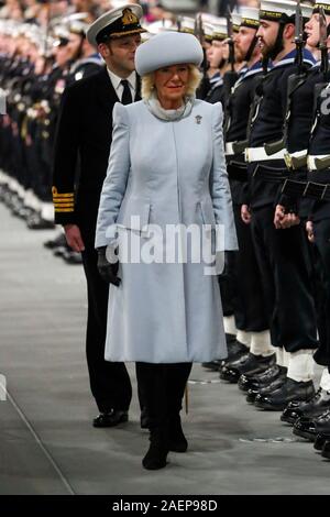 The Duchess of Cornwall inspects members of the ship's company during the commissioning ceremony of the Royal Navy aircraft carrier, HMS Prince of Wales, at Portsmouth Naval Base. Stock Photo