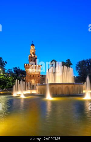 The Sforza Castle with the fountain illuminated at blue hour, Milan, Italy Stock Photo