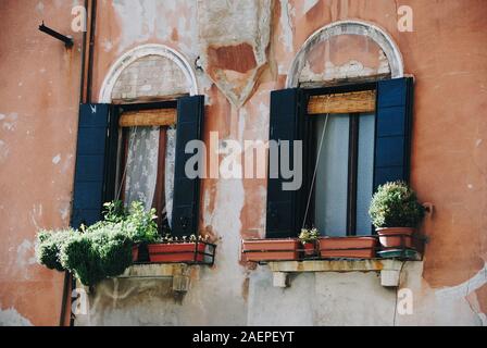 Windows in old houses facades Stock Photo