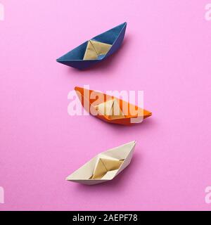 Paper ship on pink background Stock Photo