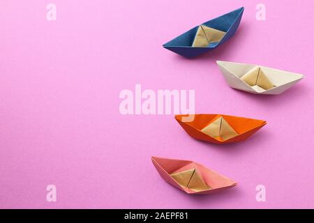 Paper ship on pink background Stock Photo