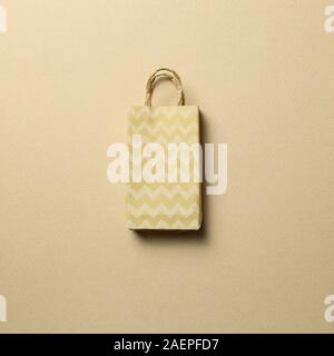 Paper shopping bag on brown background Stock Photo