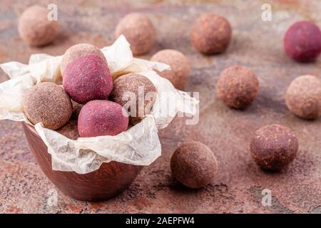 Close Up of Homemade Raw Vegan Cacao Energy Balls in Bowl with Craft Paper Stock Photo