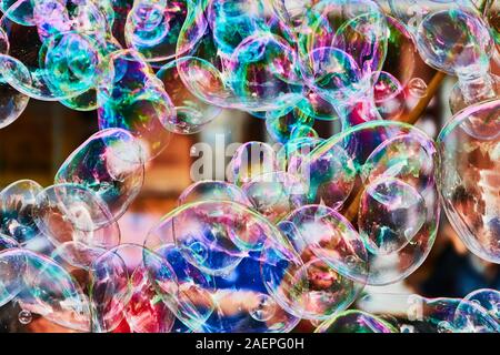 Metallic glowing colorful soap bubble in the air Stock Photo