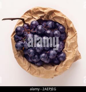 Zero waste shopping bag with blue grape isolated on white Stock Photo