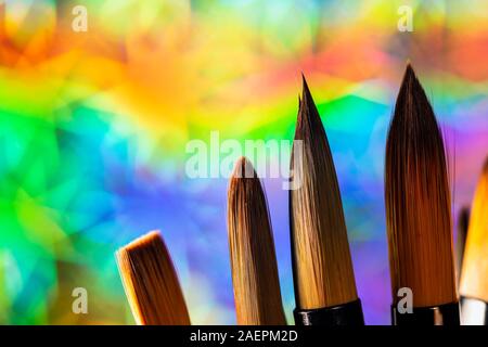 set of paint brushes on colorful holographic background with copy space for text Stock Photo