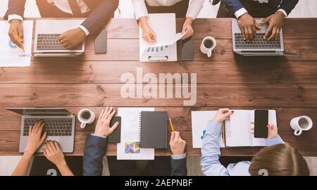 Corporate team working at office, with gadgets and documents Stock Photo