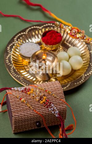 Indian Festival: Raksha Bandhan or Rakhi background with an elegant Rakhi and diya Stock Photo