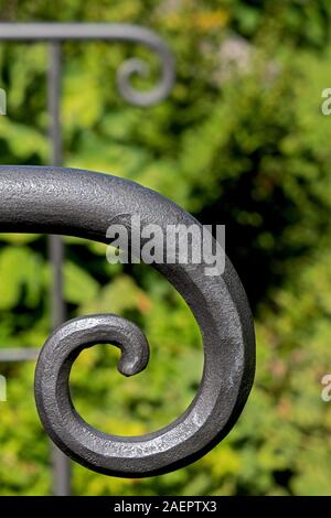 Closeup of the artforged armrests of a bench Stock Photo