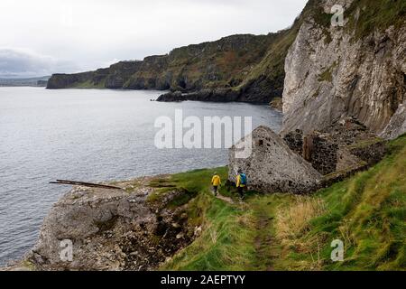 Mother and son hiking at Kinbane Castle, spectacularly situated on the Antrim coast in Northern Ireland, uk Stock Photo