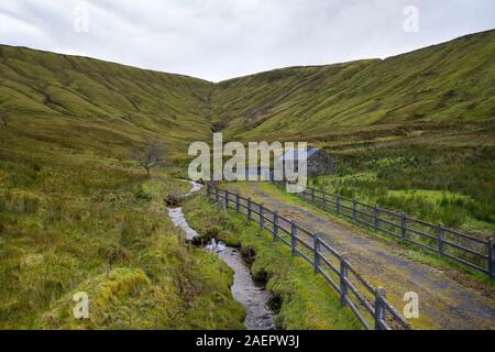 Old traditional house with wooden fence by a river stream on Gleniff Horseshoe drive in Co. Sligo, Ireland Stock Photo