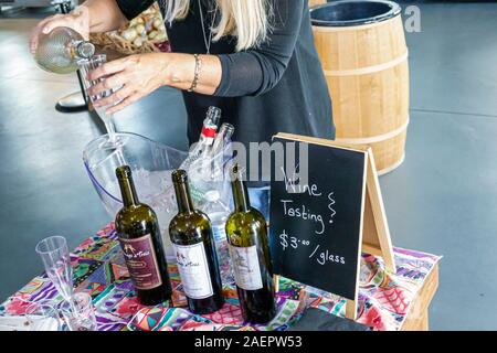 St. Saint Cloud Florida,Harmony,planned community,Town Square Market Groceries,store,wine testing,woman,pouring wine,FL190920080 Stock Photo