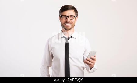 Smiling Man Using Mobile Phone Standing Over White Background, Panorama Stock Photo