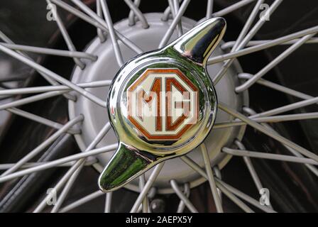 Bethlehem, PA - June 10, 2007: Close up detail of an MG logo on a 2 eared knockoff of the wire wheel of a vintage British automobile. Stock Photo