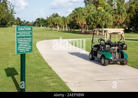 Miami Beach Florida,Normandy Isle Golf Club course,fairway,cart,sign,caution sign,FL190920179 Stock Photo