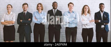 Diverse millennial business team with crossed hands Stock Photo