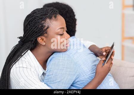 African woman cheating on her husband, talking with lover Stock Photo