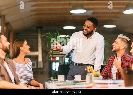 Brainstorming meeting. Chief designer talking with colleagues Stock Photo