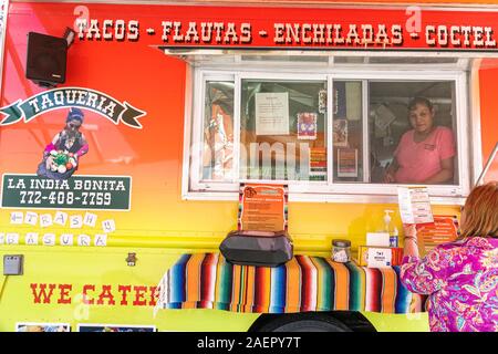 Indiantown Florida,food truck,small business,Mexican food,tacos,flautas,enchiladas,taqueria,vendor window,Hispanic,woman,ordering,FL191110039 Stock Photo