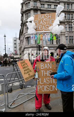 Man holding 'Ban This Plastic Poison'  placard in solo demonstration against the use of plastic in Westminster City of London England UK  KATHY DEWITT Stock Photo