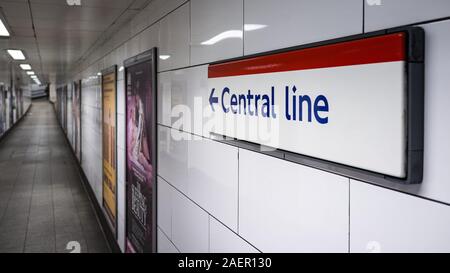 Central Line sign. Direction sign on the wall of a London Underground station pointing travellers in the direction of the red Central Line. Stock Photo