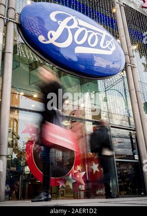 LONDON, UK - 23 NOVEMBER 2011: Boots the Chemist. Blurred shoppers walking past the shop front to the Boots store on London's Oxford Street. Stock Photo