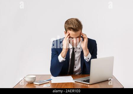 Failure, fatigue and depression concept. Man having bad day, feeling let down, losing important case in court, sitting office table with laptop and Stock Photo