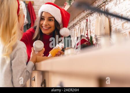 Mother in a Santa hat playing with her child Stock Photo