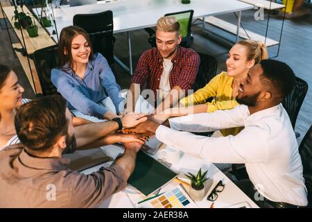 Successful team putting hands together, showing connection and alliance Stock Photo