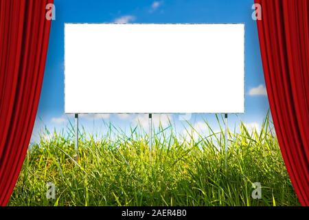 Blank advertising billboard immersed in a rural scene - concept image with open theater red curtains Stock Photo