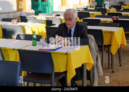 Elderly man sitting in restaurant, Cafe Martinho Da Arcada, Madalena, Lisbon, Portugal Stock Photo
